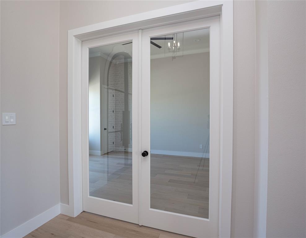 Glass doors open to an office.