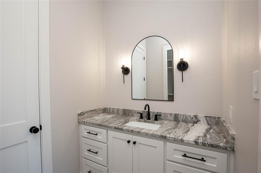 This bedroom has its own sink area.