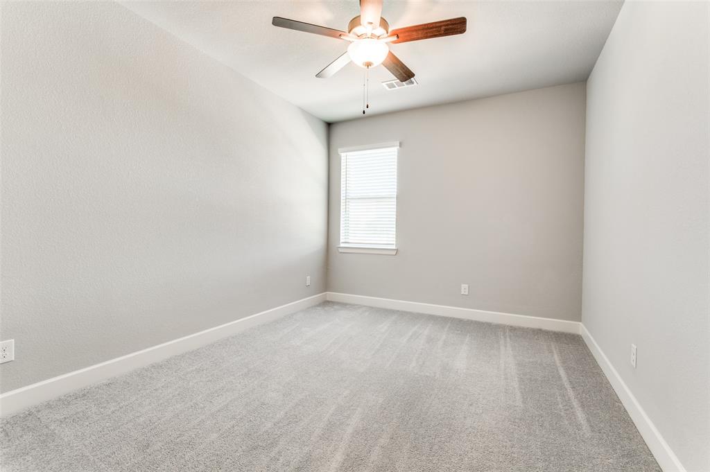 Neutral-toned wall finishes, light gray carpet, and a ceiling fan with integrated lighting Neutral-toned wall finishes, light gray carpet, and a ceiling fan with integrated lighting