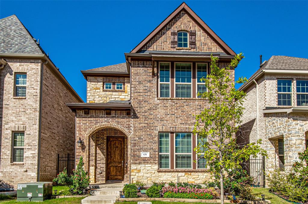 Brick and stone facade with an arched entryway Brick and stone facade with an arched entryway