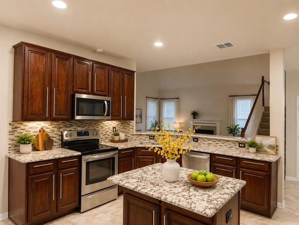Kitchen featuring dark wood-finish cabinetry, granite countertops, tile backsplash, stainless steel appliances, and a central island