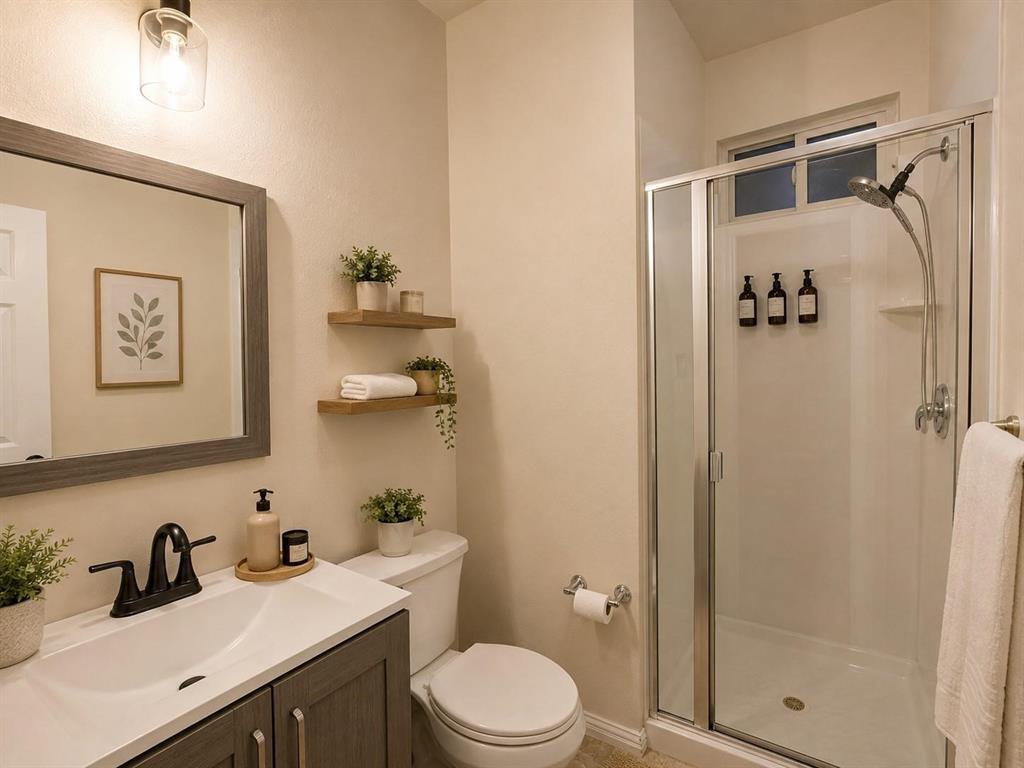 Modern vanity with a white countertop and dark gray cabinetry, framed mirror, and matte black faucet