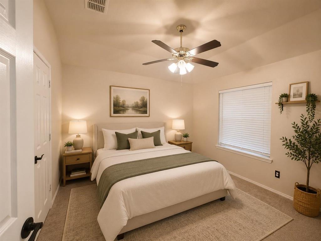 Carpeted room with a ceiling fan, window with blinds, and white door