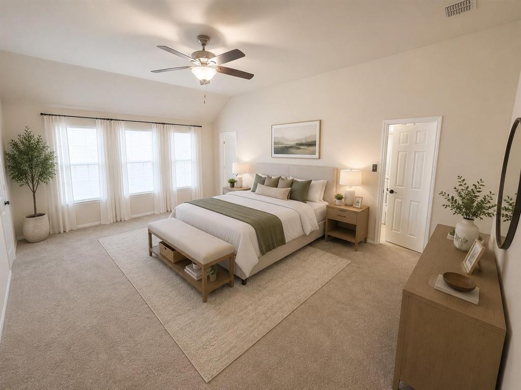 Vaulted ceiling, ceiling fan with integrated lighting, three large windows, neutral carpet flooring, and a paneled door