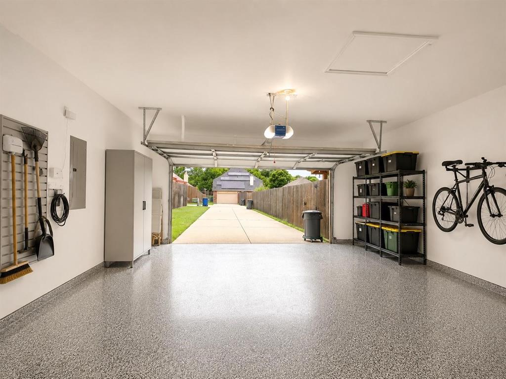 Epoxy-coated flooring, built-in storage cabinets, and a garage door opener system