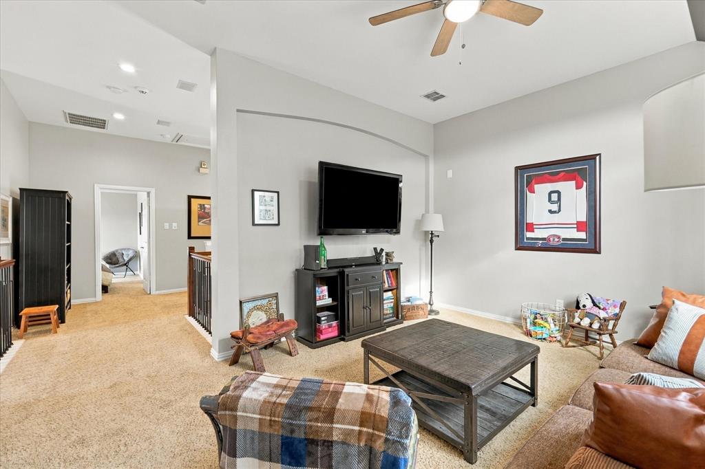 Vaulted ceilings, arched wall architectural detail, neutral wall paint, and ceiling fan fixture