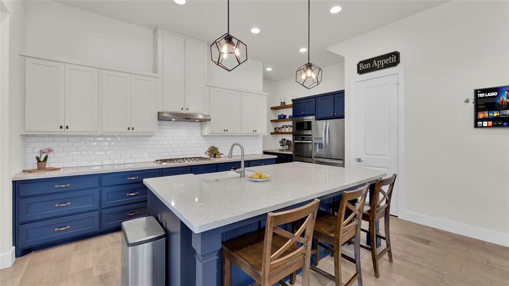 Beautiful quartz countertops, Viking cooktop, updated dishwasher, lower cabinets replaced with soft close doors. Cabinet doors under breakfast bar open for additional storage.
