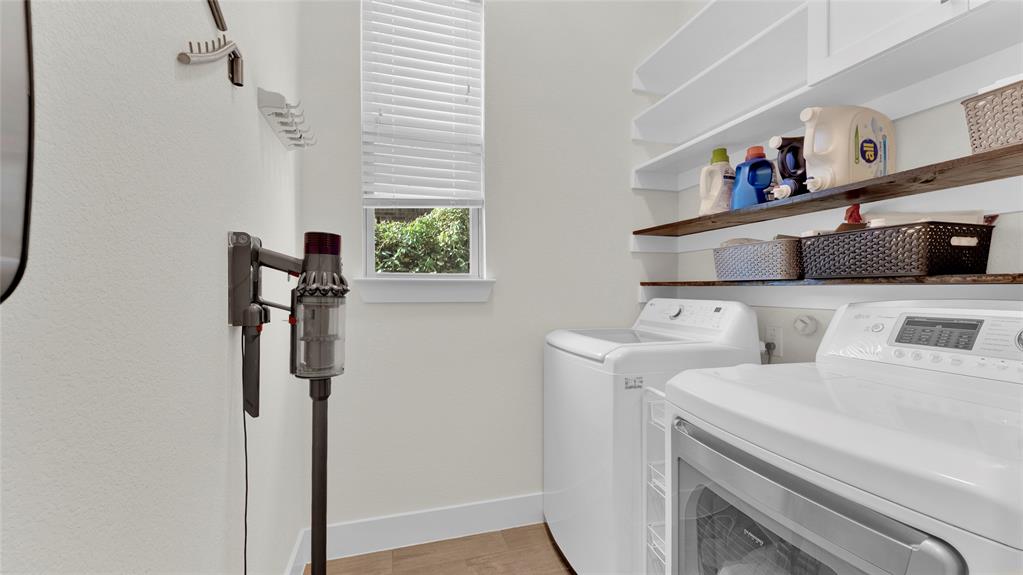 Floor 1: Laundry. Shelving and cabinet above washer and dryer. Cleaning-tool organizer rack. Two drying racks.