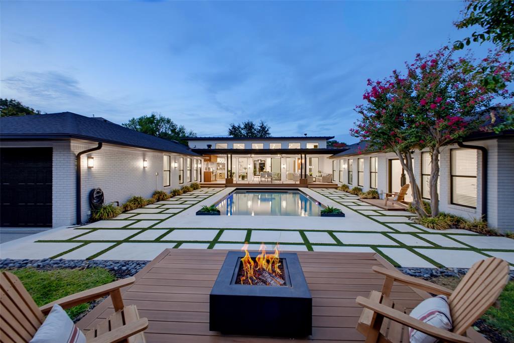 There is a grassy space to the right of the firepit