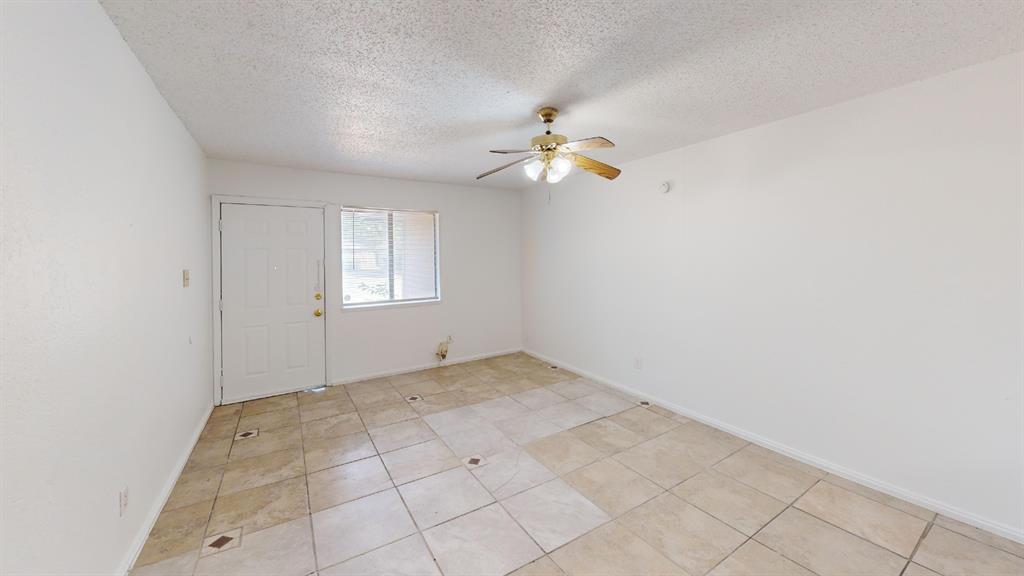 Recessed ceiling with a brass-finish ceiling fan, tiled flooring, and a window with blinds