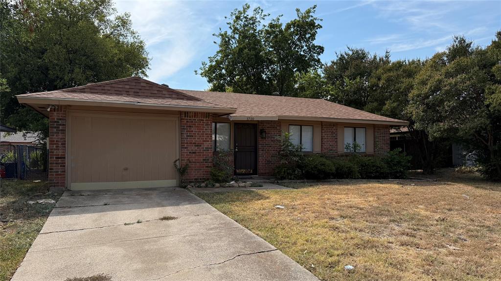 Brick exterior with a single-car garage and a concrete driveway
