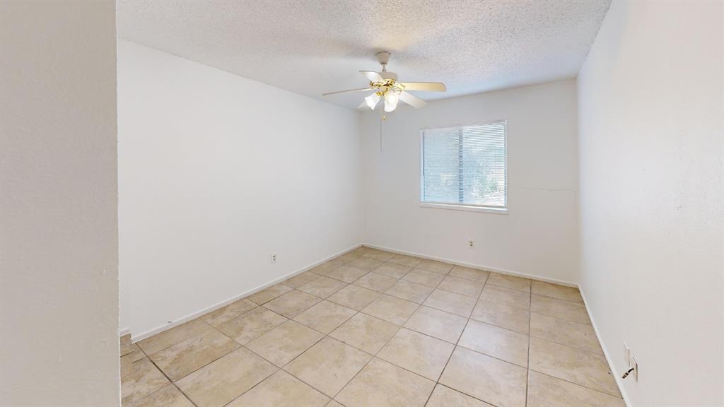 Tiled flooring, overhead ceiling fan, and a window with natural light