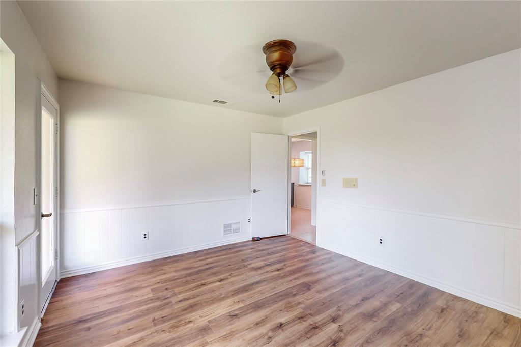Wood-finish flooring with white wainscoting and trim