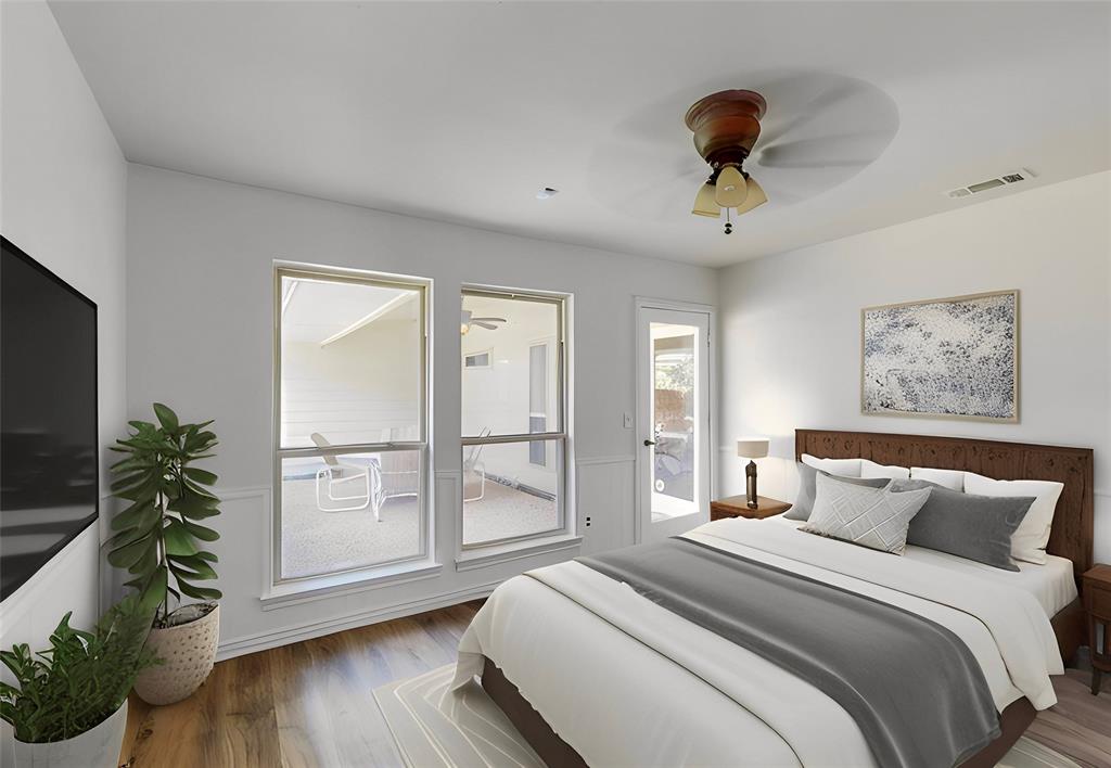 Wood-finish flooring with white baseboards, a ceiling fan with light fixture, and multiple windows