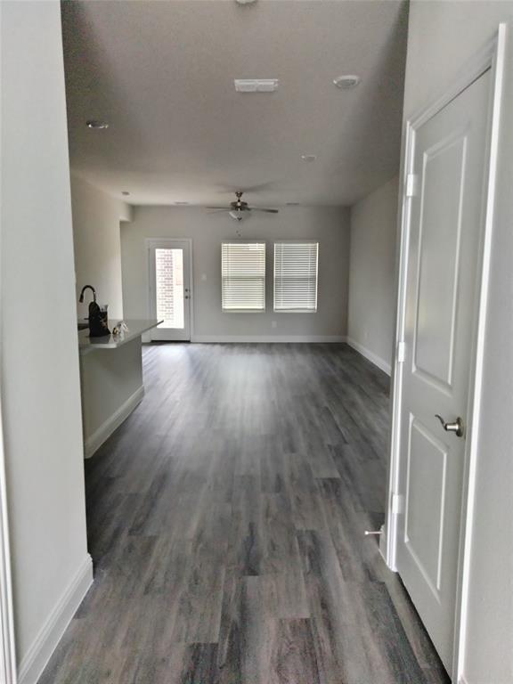 Open-concept living space featuring wood-finish flooring, recessed lighting, and a ceiling fan