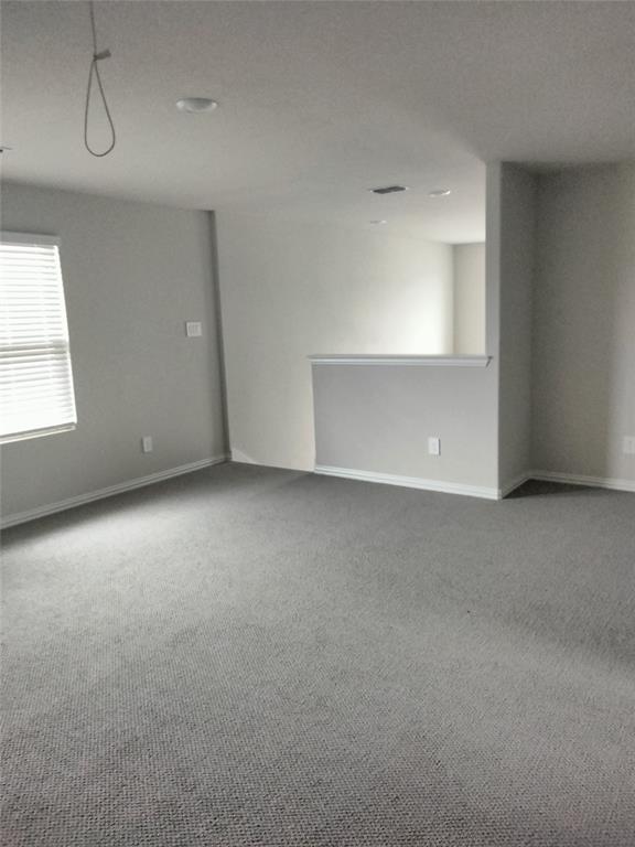 Recessed lighting, light gray carpeting, and neutral wall tones
