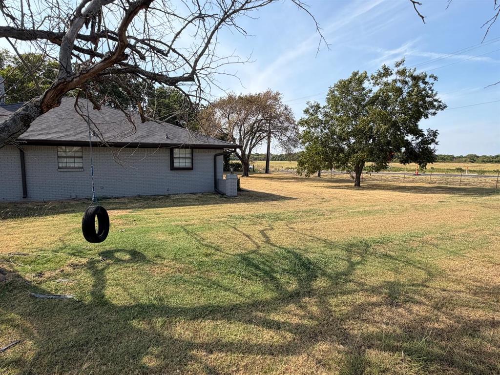 Expansive lawn with mature trees and a fenced perimeter Expansive lawn with mature trees and a fenced perimeter