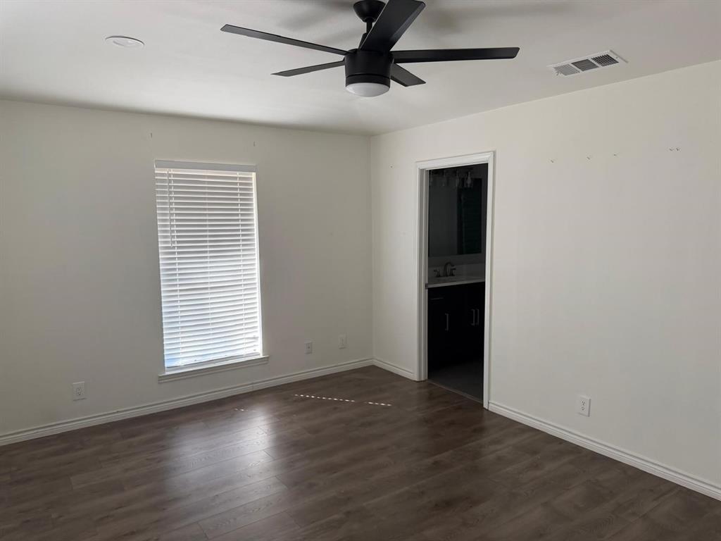Room with wood-finish flooring, a window with blinds, and a modern ceiling fan