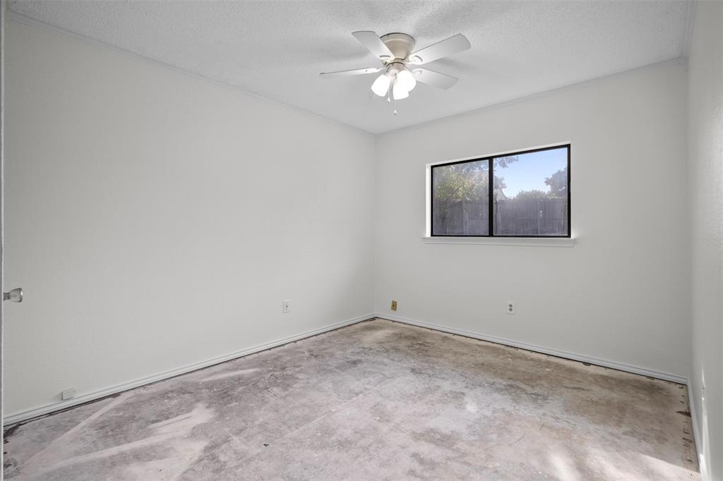 Room featuring neutral-toned walls, a white ceiling fan with integrated light fixture, and a single-pane horizontal window with black trim