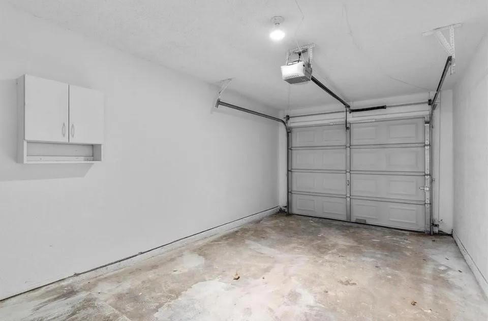 A spacious garage with a hanging cabinet