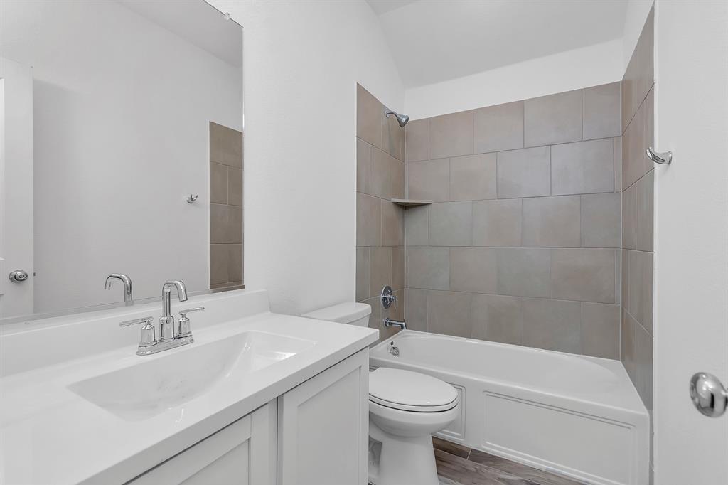 Full bathroom with vanity, shower / bathtub combination, and wood finished floors