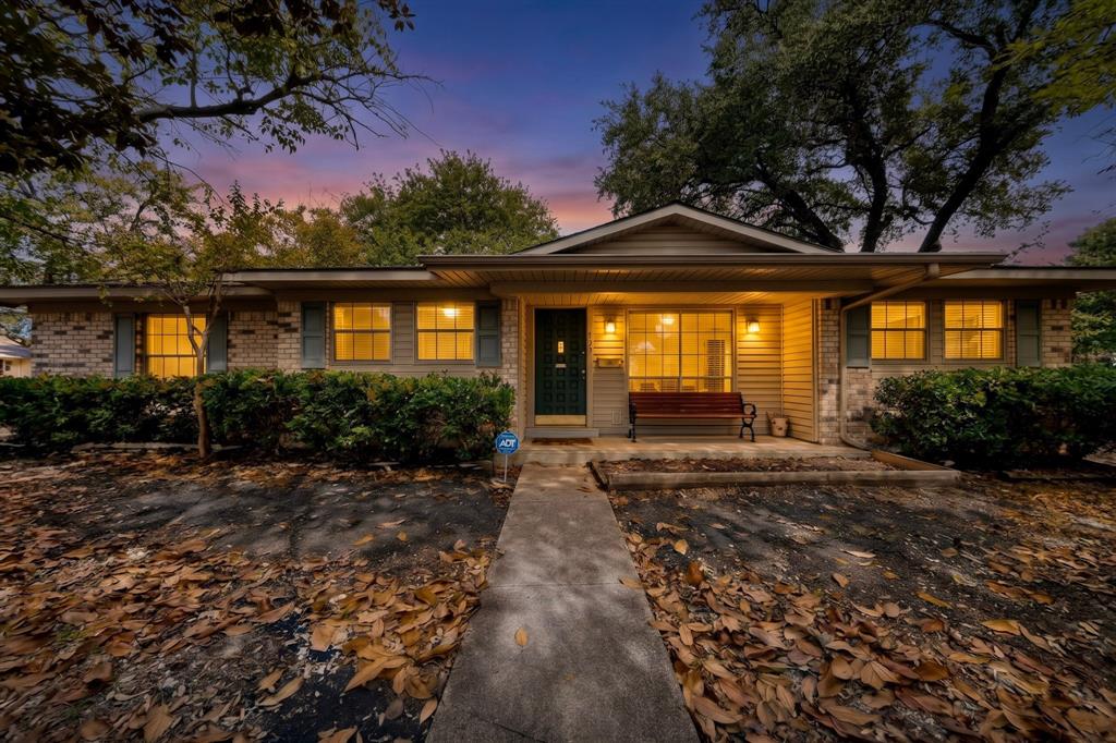 Brick and siding exterior with a covered entry, established landscaping, and a concrete pathway Brick and siding exterior with a covered entry, established landscaping, and a concrete pathway