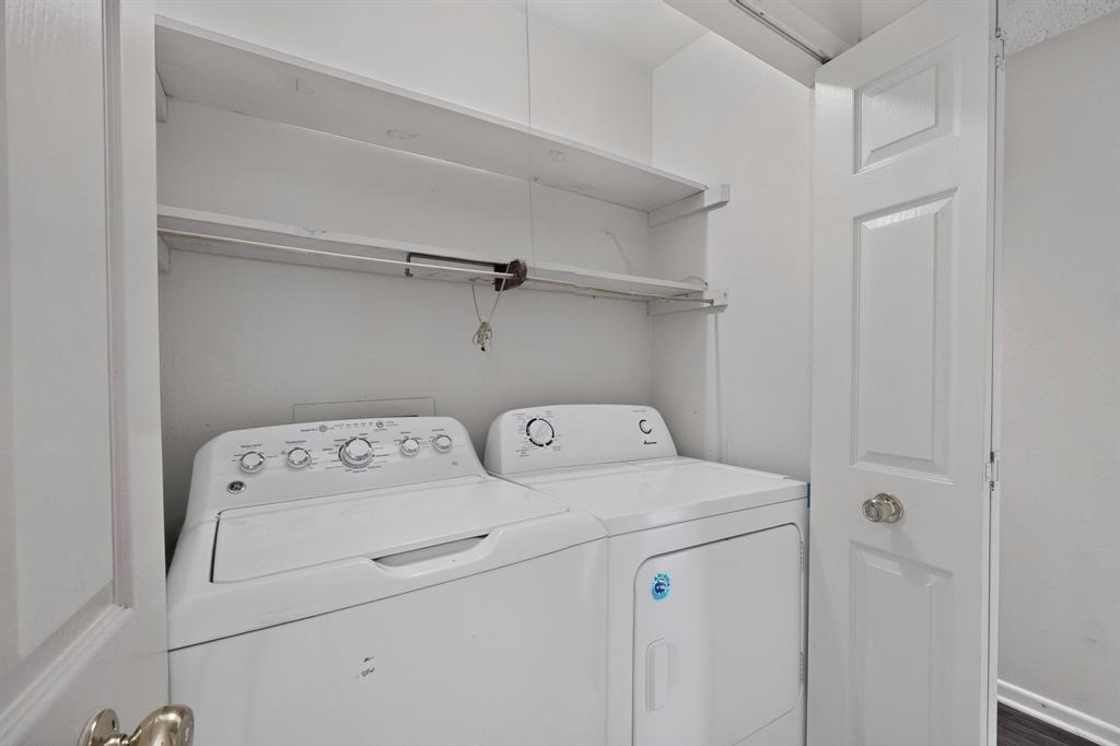Laundry closet featuring a built-in shelf and white paneled doors