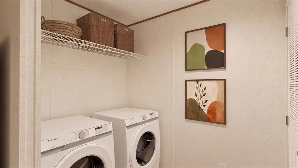 Laundry area featuring high-efficiency front-loading washer and dryer, white paneling, and elevated wire shelving