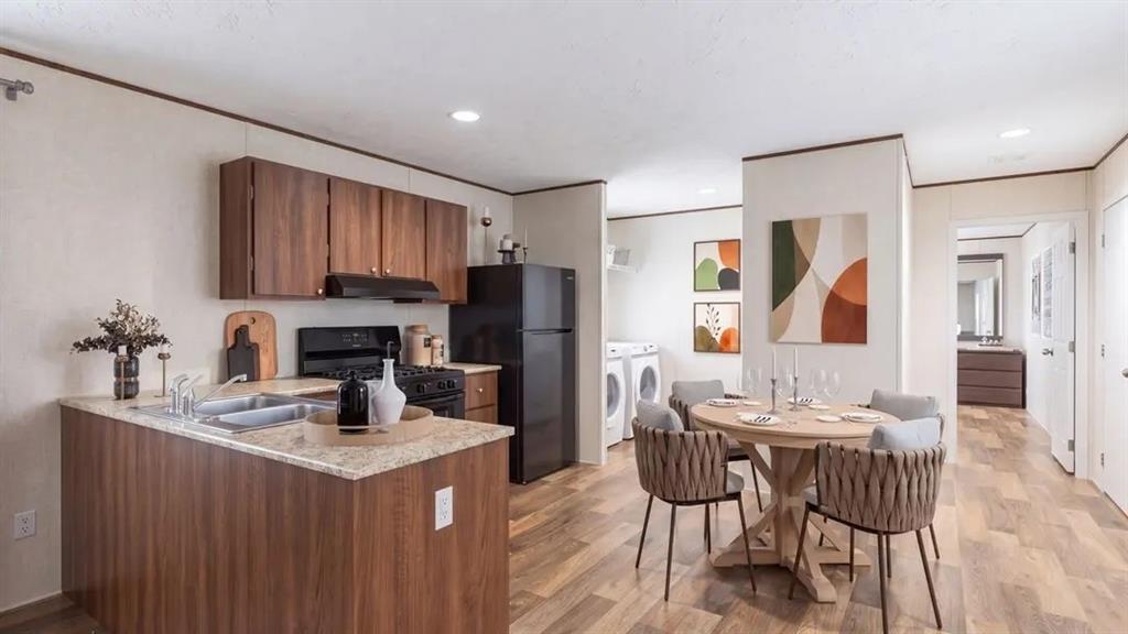 Kitchen featuring wood-finish cabinetry, stone-texture laminate countertops, dual-basin stainless steel sink, wood-finish flooring, and recessed lighting