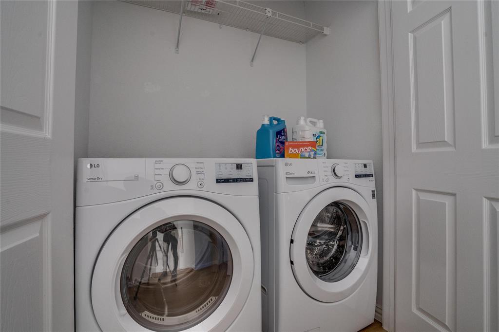 Dedicated laundry area featuring a white wire shelving unit and panel doors
