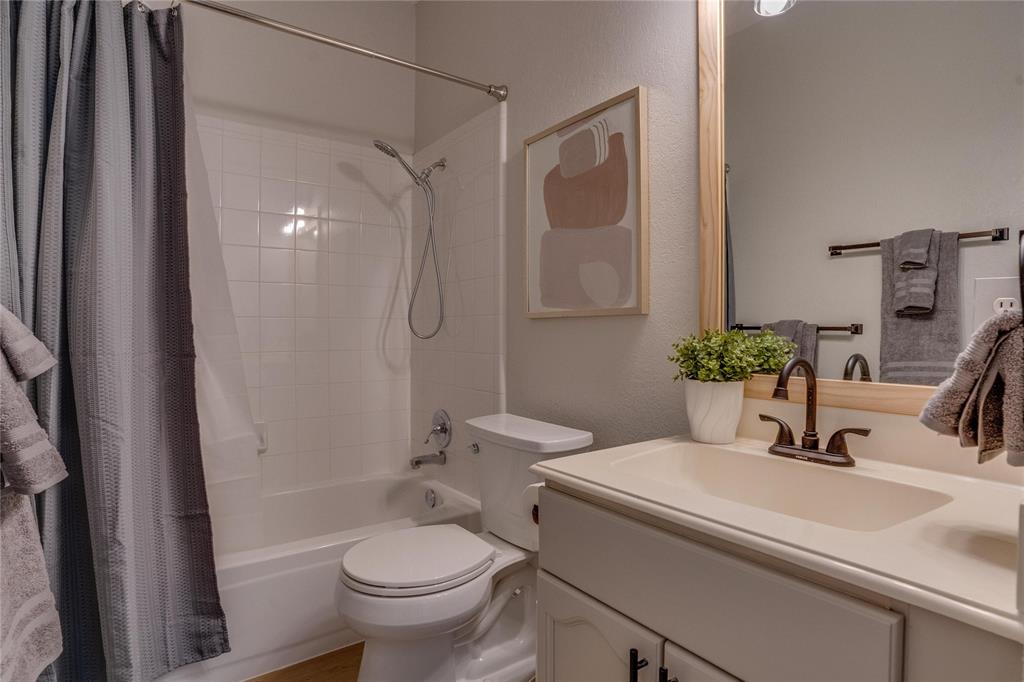 White tile shower surround over a tub with a chrome showerhead