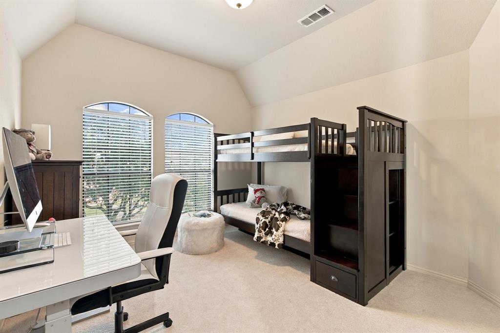 Vaulted ceiling, neutral wall tones, carpeted flooring, and dual arched windows