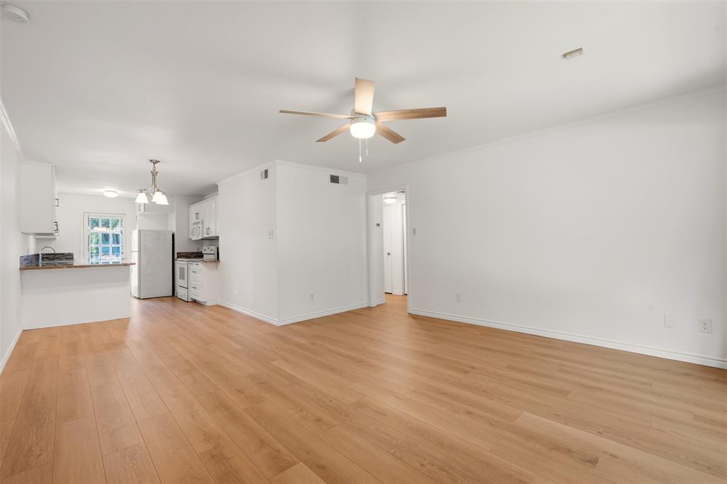 Open-concept living area featuring wood-finish flooring, a ceiling fan, and recessed lighting