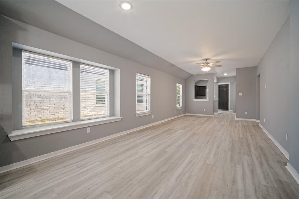 Open-concept room featuring wood-finish flooring, a recessed window seat, recessed lighting, and a ceiling fan Open-concept room featuring wood-finish flooring, a recessed window seat, recessed lighting, and a ceiling fan
