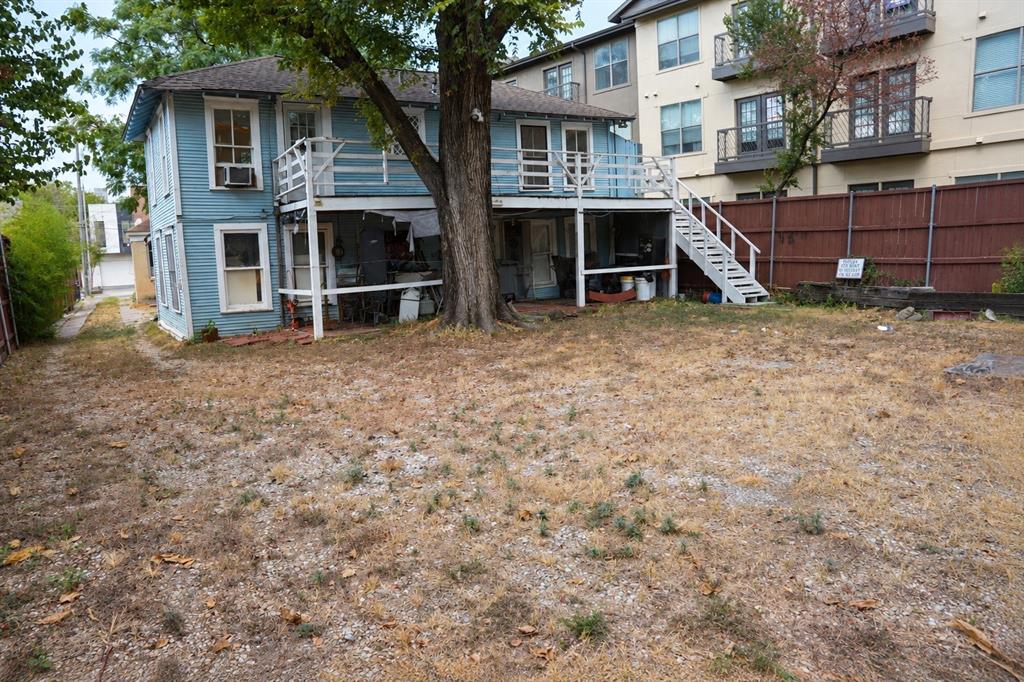 Rear elevation showing exterior access stairs and yard depth.