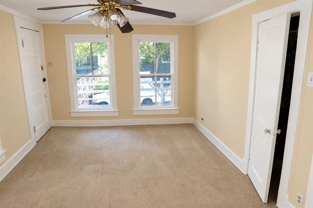 Rear duplex bedroom featuring natural light and clean flooring.