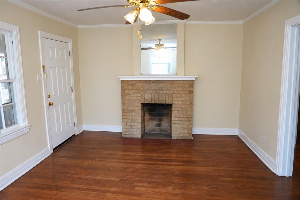 Front duplex unit living area with original hardwood flooring.