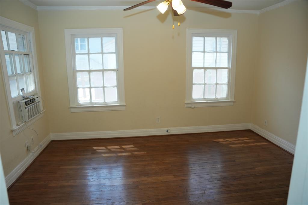 Bedroom in front duplex with dual windows and hardwood floors.