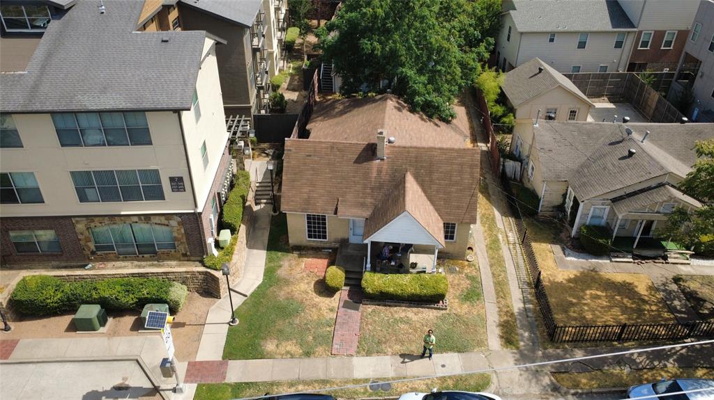 Oblique aerial view displaying property rooflines and neighboring context.