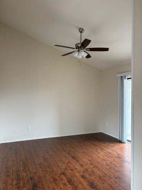 Vaulted ceiling with a ceiling fan light fixture, wood-finish flooring, and a sliding glass door
