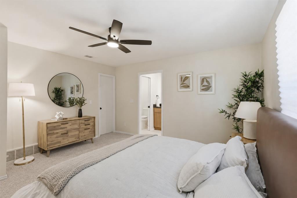 Room featuring neutral wall tones, carpeted flooring, and a ceiling fan with integrated lighting