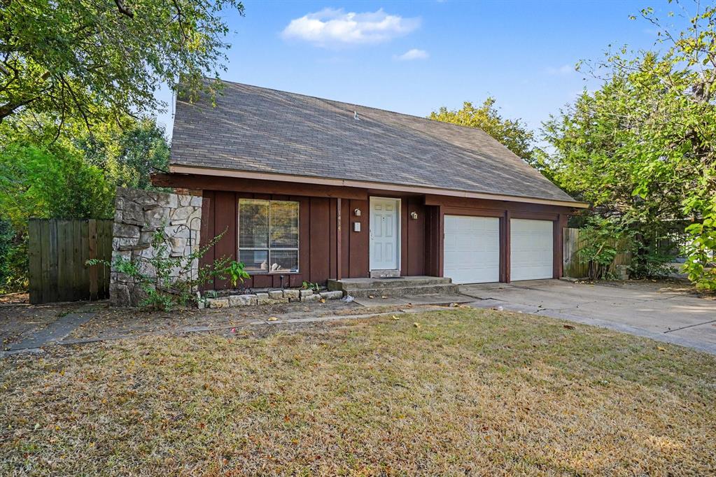 Wood siding exterior with stone accents, featuring a two-car garage, front entry door, and asphalt shingle roof