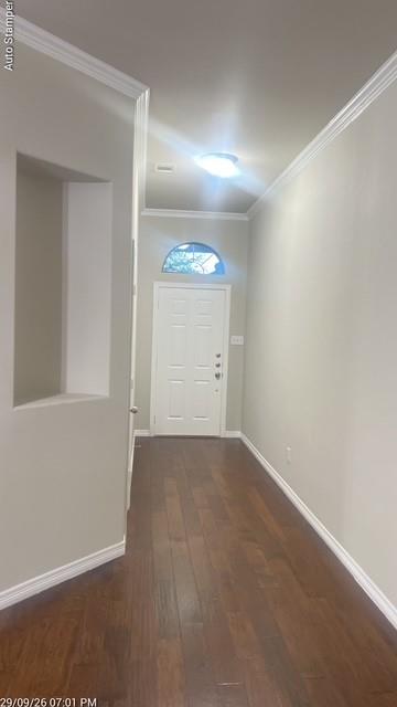 Entryway featuring wood-finish flooring, a white paneled door with an arched transom, and crown molding
