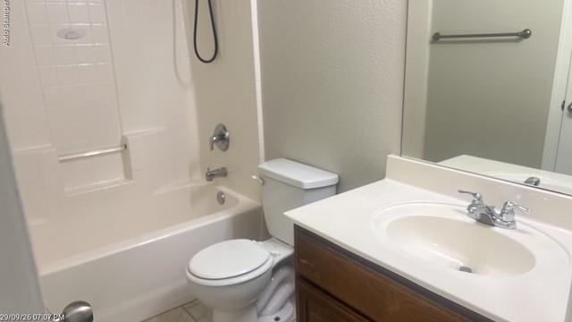 White bathtub with integrated shower, single-handle faucet, and built-in grab bar