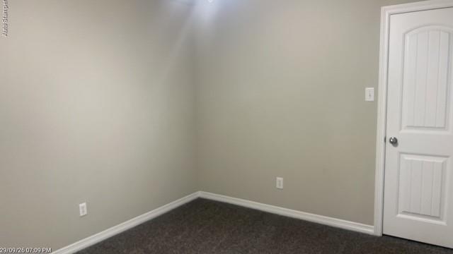 Neutral wall paint, textured carpeting, crisp white trim, and a paneled interior door