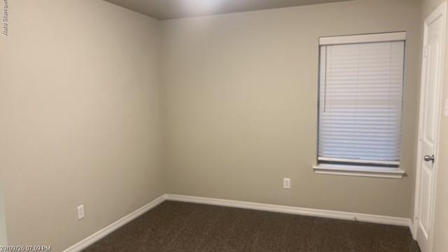 Neutral wall tones, carpeted flooring, window with blinds, and white trim throughout