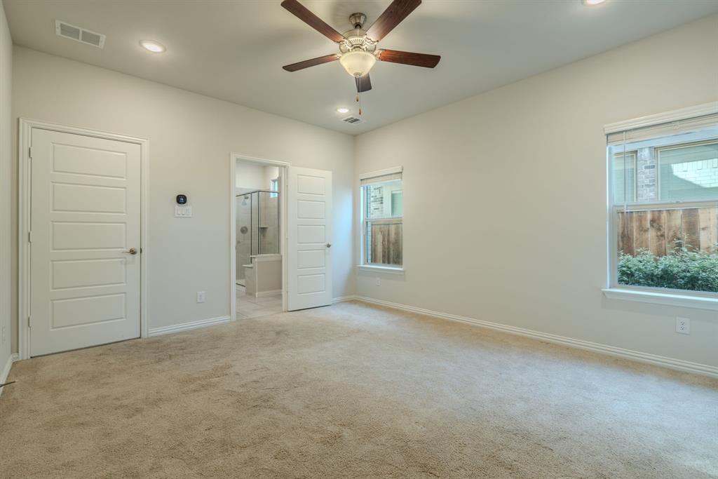 Primary Bedroom with ensuite bathroom and ceiling fan