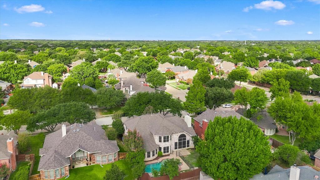 LOCATION, BEAUTY, AND NEIGHBORHOOD CHARM! A spectacular panoramic view reveals a canopy of mature trees, beautiful established homes, and the inviting character of this Flower Mound neighborhood.