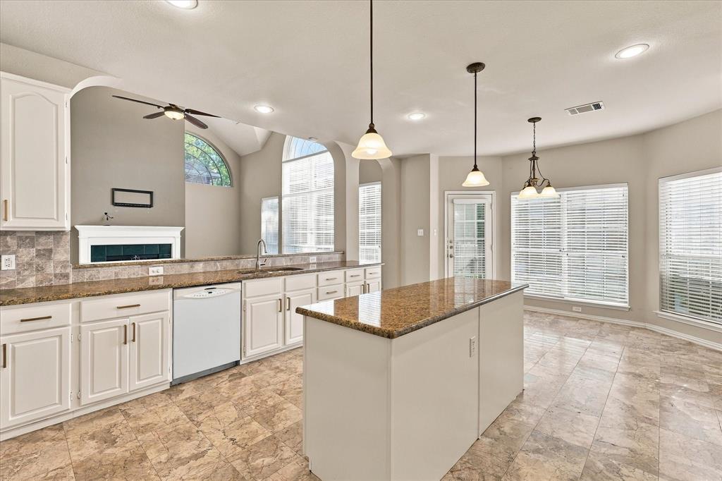 DESIGNED FOR GATHERING IN STYLE! This spacious kitchen combines generous counter space, beautiful freshly painted cabinetry with new hardware, an impressive center island, and a sun-filled breakfast area, all overlooking the home's spectacular living room and fireplace.