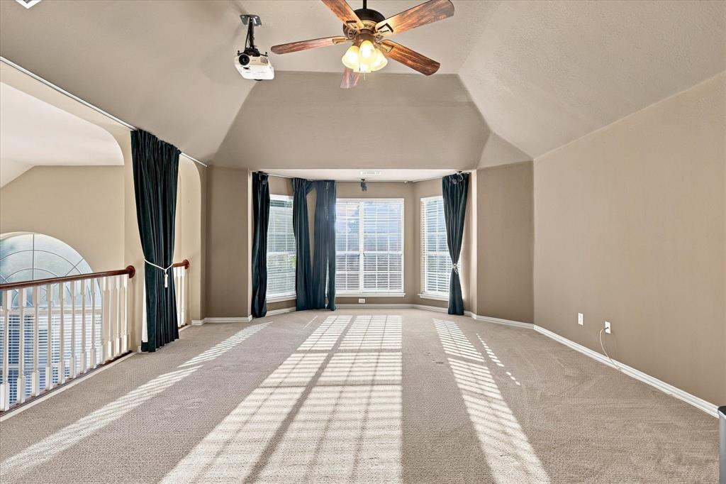 ENTERTAINMENT POSSIBILITIES ARE ENDLESS! This impressive upstairs retreat features vaulted ceilings, fresh paint, a spacious open layout, a ceiling-mounted projector, and walls of windows that flood the room with natural light.
